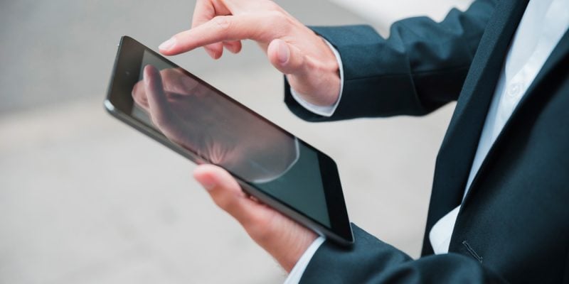 close-up-businessman-s-hand-using-digital-tablet